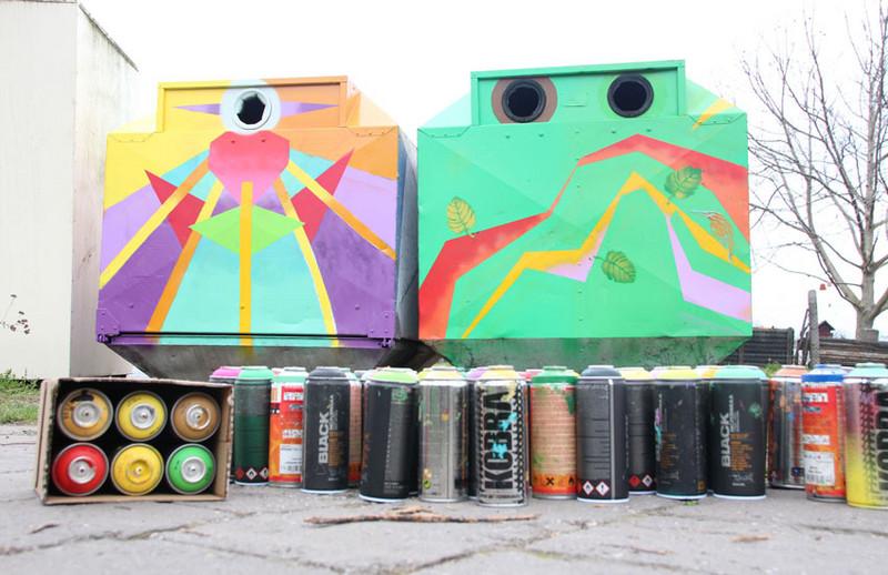 Verbrauchte Grafitti-Dosen vor gestaltetem Container
